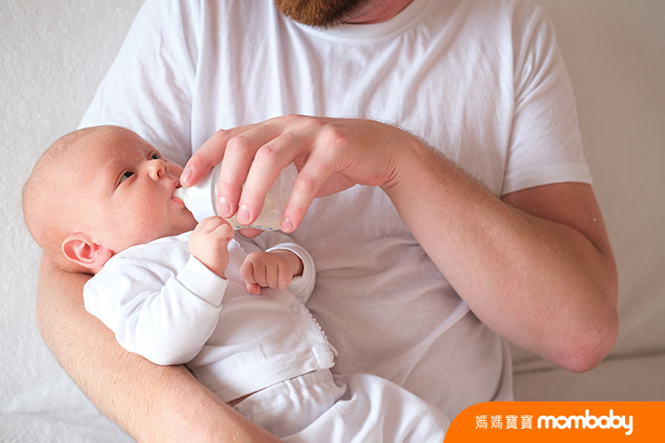 A,Father,Holds,And,Bottle,Feeds,His,Newborn,Baby.,The
